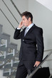 Businessman On Call Walking Down The Stairs