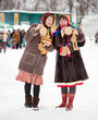 Women  tasting pancake  during  Shrovetide