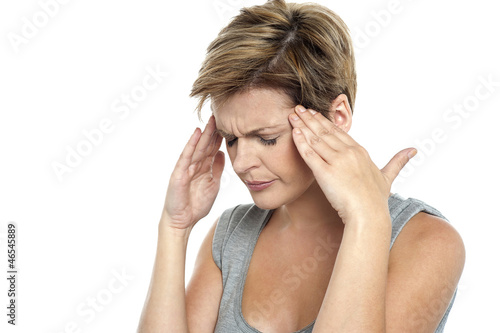 Photo: Woman having headache. Holding her head Woman having headache. Holding her head