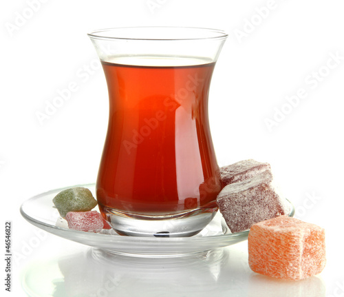 Photo: glass of Turkish tea and rahat Delight, isolated on white glass of Turkish tea and rahat Delight, isolated on white