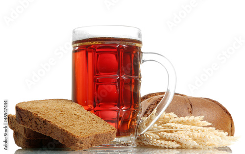 Photo: tankard of kvass and rye breads with ears, isolated on white tankard of kvass and rye breads with ears, isolated on white