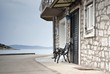 Old street of stone houses with bench by the sea