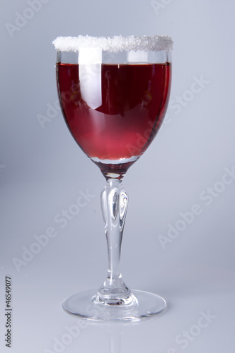 Photo: Wine glass close-up, decoration on the edge of a white crumb Wine glass close-up, decoration on the edge of a white crumb