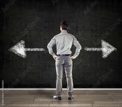 Photo: young business man in front of a blackboard young business man in front of a blackboard