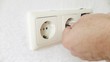 Man installs an electrical socket