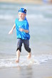 Boy frolics on the beach