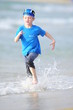Boy frolics on the beach
