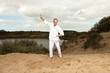 Photo: Senior spiritual man dressed in white. Exercising outdoors. Senior spiritual man dressed in white. Exercising outdoors.