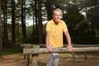 Photo: Senior man stretching his legs. Doing workout in nature. Senior man stretching his legs. Doing workout in nature.