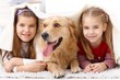 Little sisters having fun with pet dog