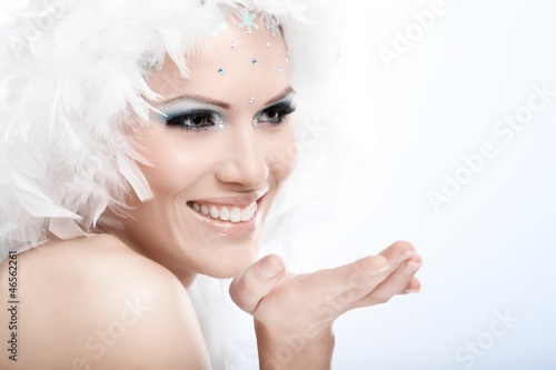 Photo: Winter portrait of beautiful young woman smiling Winter portrait of beautiful young woman smiling