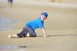 Boy frolics on the beach