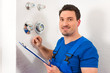 Technician reading the water meter