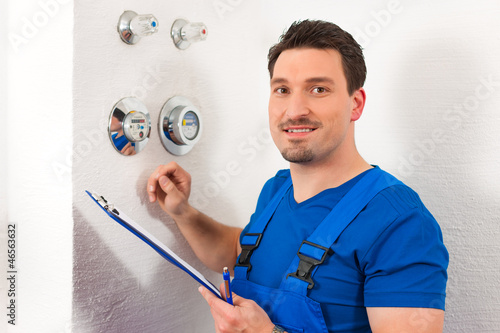 Photo: Technician reading the water meter Technician reading the water meter