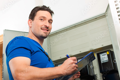 Photo: Technician reading the electricity meter Technician reading the electricity meter