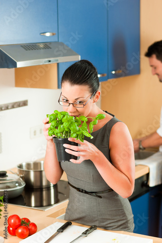 Photo: Couple cooking together in kitchen Couple cooking together in kitchen