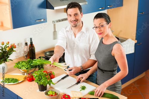 Photo: Couple cooking together in kitchen Couple cooking together in kitchen