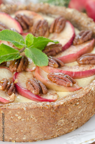Photo: cheesecake with apples and caramelized pecans closeup selective cheesecake with apples and caramelized pecans closeup selective