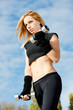 Beautiful fit woman exercising  outdoors over a sky background