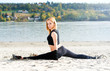 Beautiful fit woman stretching on the beach