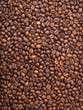 Numerous coffee beans which have been scattered all over the sur