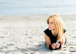 Woman relaxing on the beach after a workout