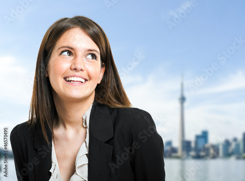 Photo: Beautiful businesswoman with city background Beautiful businesswoman with city background