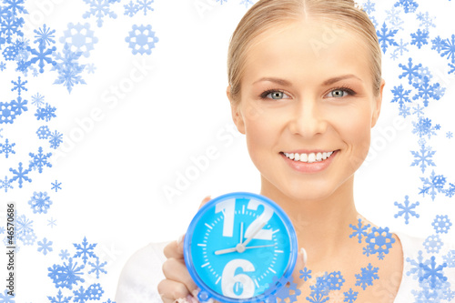 Photo: woman holding alarm clock woman holding alarm clock