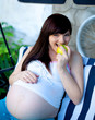 portrait of pretty young woman expecting a baby,outdoors,