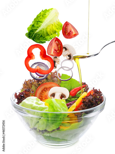 Photo: salad of fresh vegetables falling in a bowl salad of fresh vegetables falling in a bowl