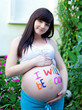 Photo: portrait of pretty young woman expecting a baby,outdoors, portrait of pretty young woman expecting a baby,outdoors,