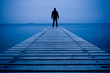 Foto: Man standing on a wooden pier Man standing on a wooden pier