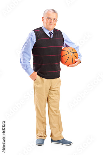 Photo: Full length portrait of a gentleman holding a basketball Full length portrait of a gentleman holding a basketball