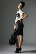 portrait of standing young woman jeans holding handbag posing