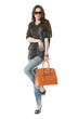 casual young fashion mode in sunglasses with handbag