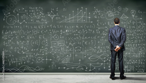 Photo: Business person against the blackboard Business person against the blackboard