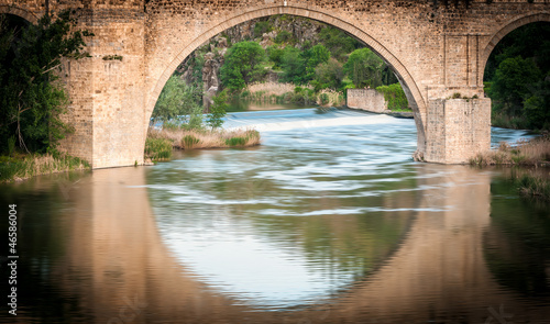 Photo: Bridge reflects in river of Toledo, Spain, Europe. Bridge reflects in river of Toledo, Spain, Europe.