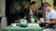 Young couple drinking wine on the balcony in the evening
