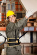 Foreman Lifting Cardboard Box At Warehouse