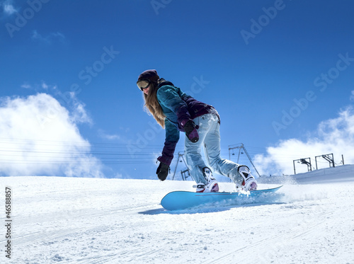 Photo: Snowboarder moving down Snowboarder moving down