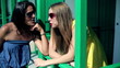 Portrait of talking female friends, outdoors, steadycam shot 