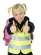 Cute child with reflective vest showing thumbs up