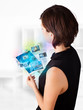 Young woman browsing pictures on modern tablet