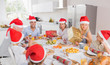 Smiling family around the dinner table at christmas