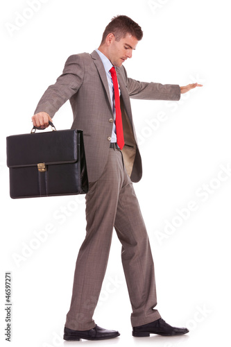 Photo: business man with briefcase balancing business man with briefcase balancing