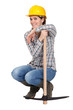 Woman kneeling by a pickax