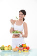 Woman eating a plateful of salad leaves