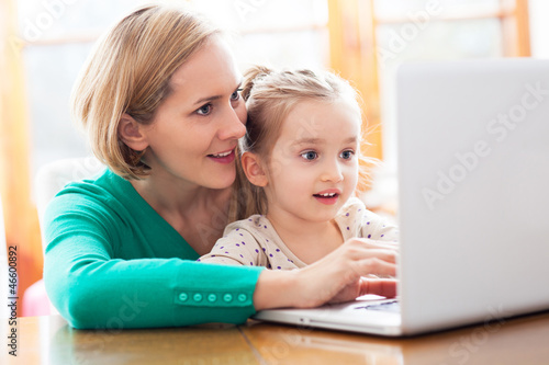 Photo: Daughter and mother looking at a laptop Daughter and mother looking at a laptop