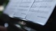 Music sheets and woman practising the song at the piano