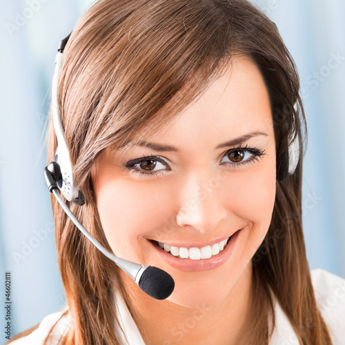 Photo: Happy smiling support phone operator at office Happy smiling support phone operator at office